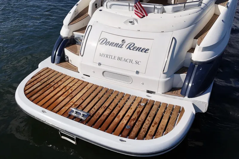 Slide: The Image of Sunseeker Predator 56 yacht, 2000 model, docked in Myrtle Beach, SC, with wooden deck. - 8