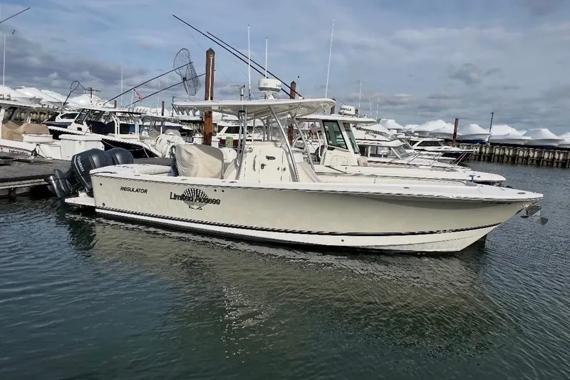 The Image of 2015 Regulator 28 Forward Seating boat docked in a marina. - 1