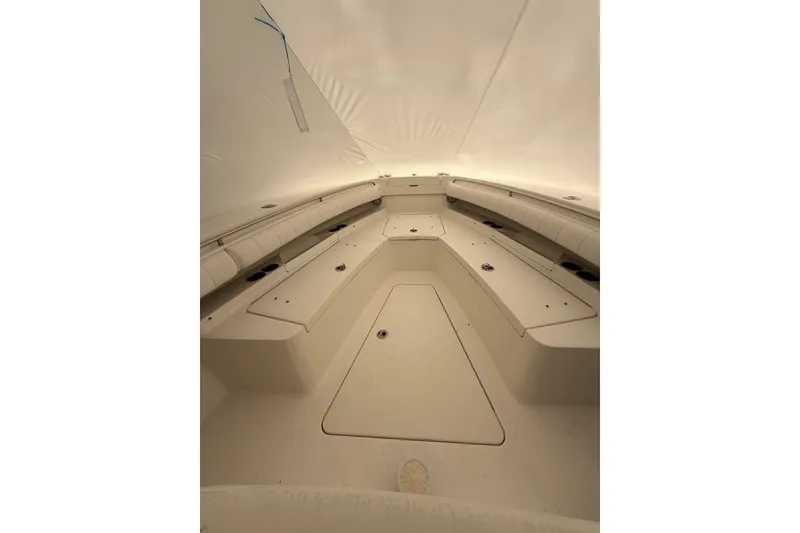 Slide: The Image of 2015 Regulator 28 Forward Seating boat interior, showcasing spacious seating and storage areas. - 19