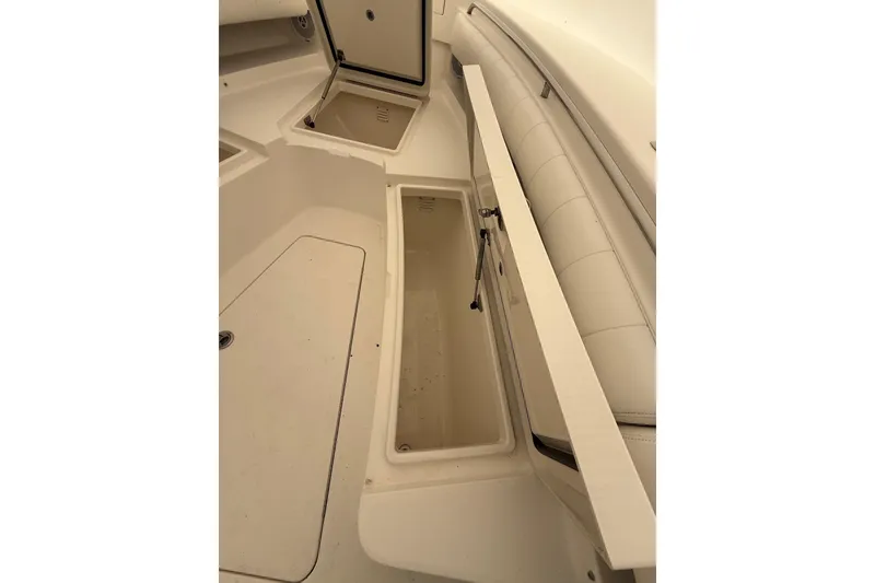 Slide: The Image of 2015 Regulator 28 Forward Seating boat interior with open storage compartments. - 21
