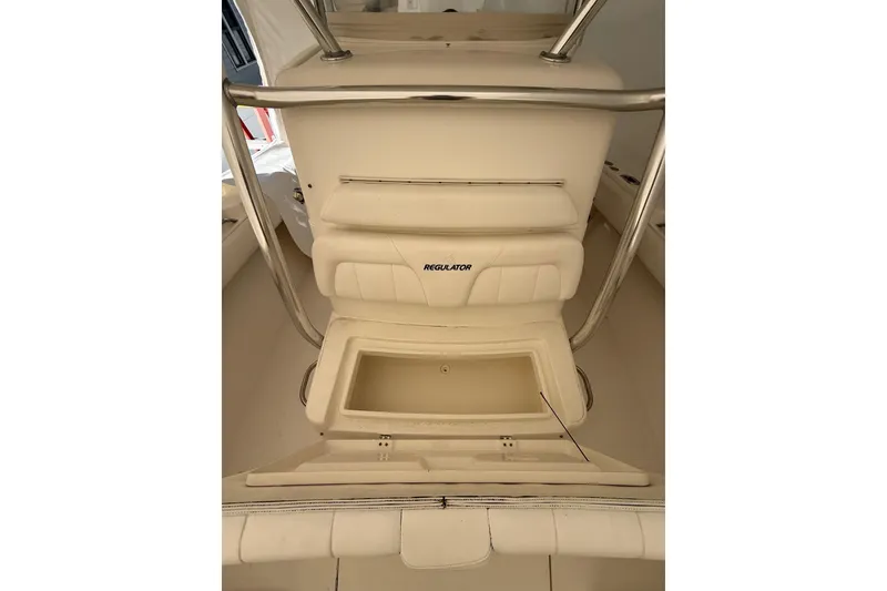 Slide: The Image of 2015 Regulator 28 Forward Seating boat interior with storage compartment open. - 25