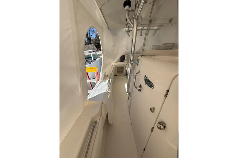 Slide: The Image of 2015 Regulator 28 Forward Seating boat interior with white finish and stainless steel fixtures. - 29