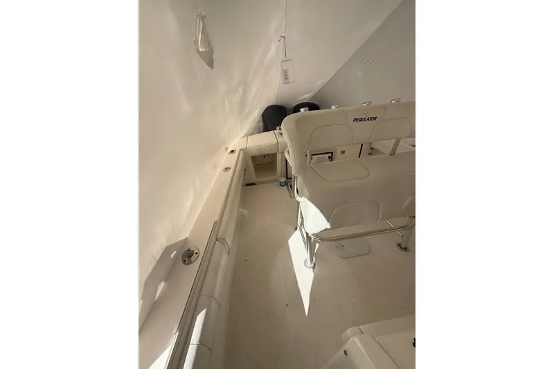 Slide: The Image of 2015 Regulator 28 Forward Seating interior with white cushioned seats and sleek design. - 30