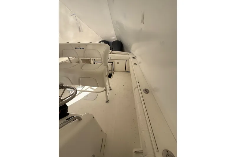 Slide: The Image of 2015 Regulator 28 Forward Seating boat interior with white seating and steering wheel. - 31