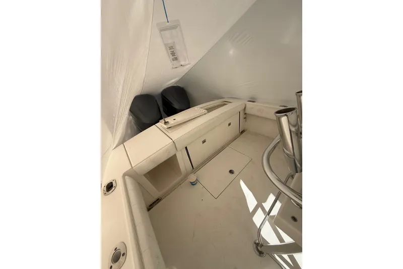 Slide: The Image of 2015 Regulator 28 Forward Seating boat interior with storage and seating area. - 33