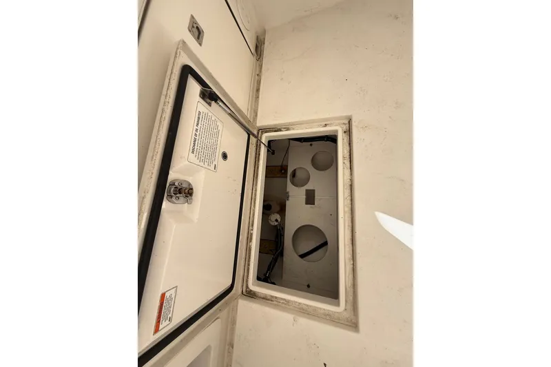Slide: The Image of Open storage compartment on a 2015 Regulator 28 Forward Seating boat. - 34