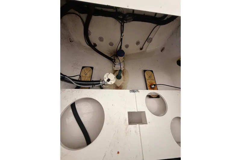 Slide: The Image of 2015 Regulator 28 Forward Seating boat interior with visible wiring and components. - 36