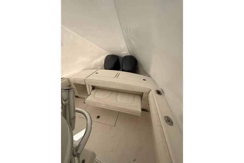 Slide: The Image of 2015 Regulator 28 Forward Seating boat interior with foldable seat and storage. - 38