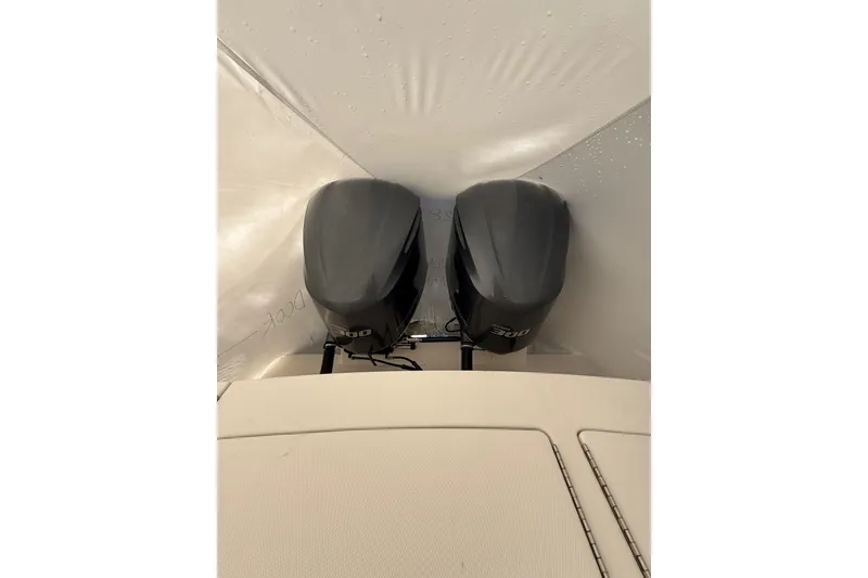 Slide: The Image of 2015 Regulator 28 Forward Seating with twin outboard engines, covered in protective wrap. - 40