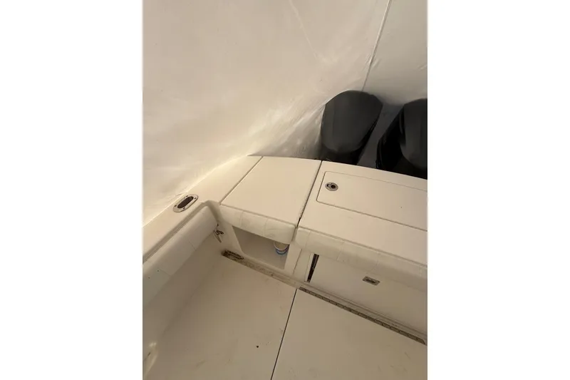 Slide: The Image of 2015 Regulator 28 Forward Seating boat interior with storage compartments and dual engines. - 41