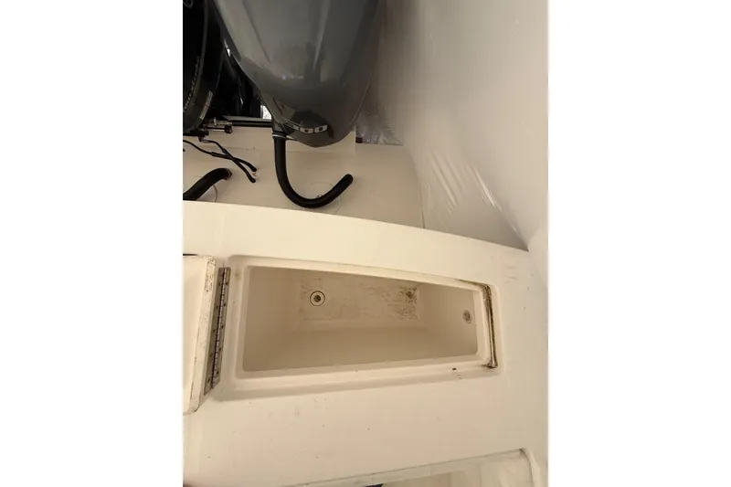 Slide: The Image of 2015 Regulator 28 Forward Seating boat interior with storage compartment and engine view. - 45