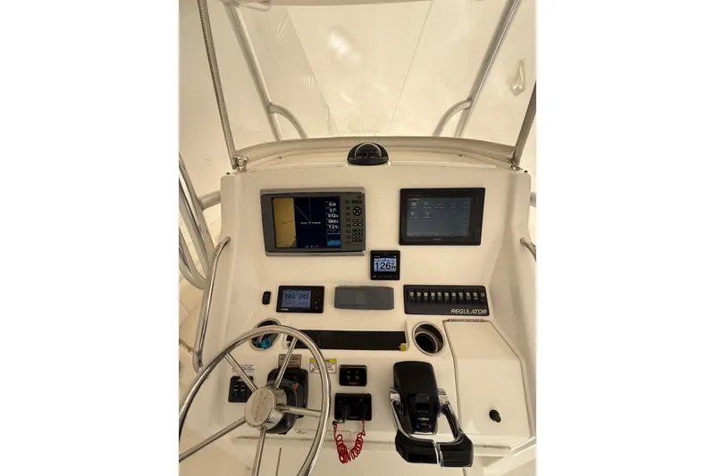 Slide: The Image of Control panel of 2015 Regulator 28 Forward Seating boat with navigation screens. - 48