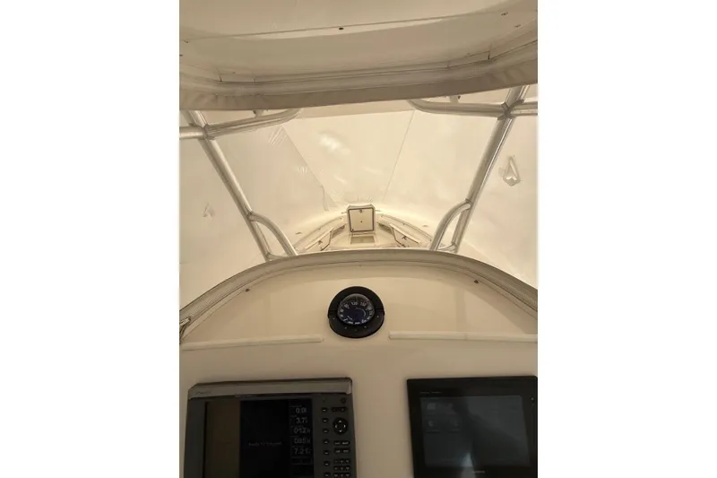 Slide: The Image of Interior view of 2015 Regulator 28 Forward Seating boat cockpit with navigation instruments. - 49
