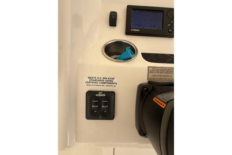 Slide: The Image of 2015 Regulator 28 Forward Seating boat dashboard with Yamaha display and Lenco controls. - 51