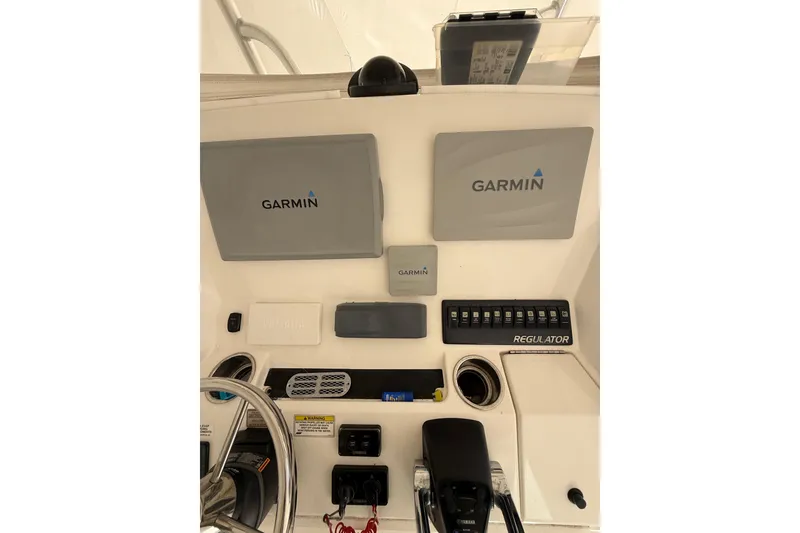 Slide: The Image of 2015 Regulator 28 Forward Seating boat dashboard with Garmin navigation displays. - 60