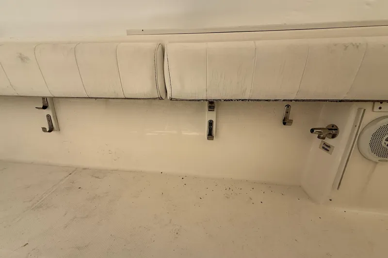 Slide: The Image of 2015 Regulator 28 Forward Seating boat interior with white cushioned seats and speaker. - 62