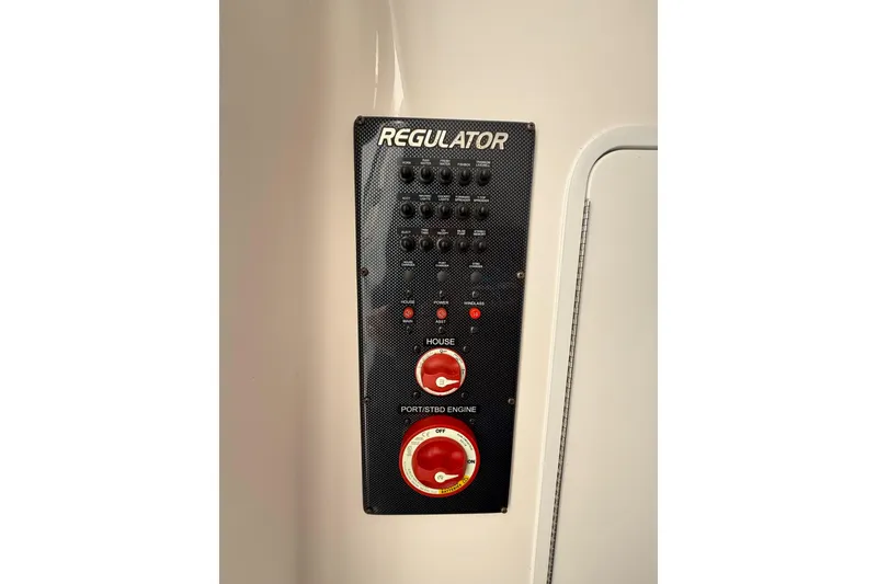 Slide: The Image of Control panel of 2015 Regulator 28 Forward Seating boat with switches and dials. - 69
