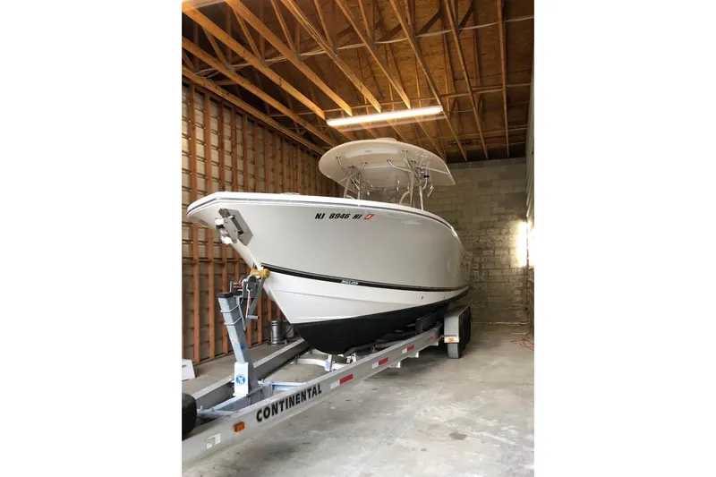 Slide: The Image of 2015 Regulator 28 Forward Seating boat on trailer in storage facility. - 7