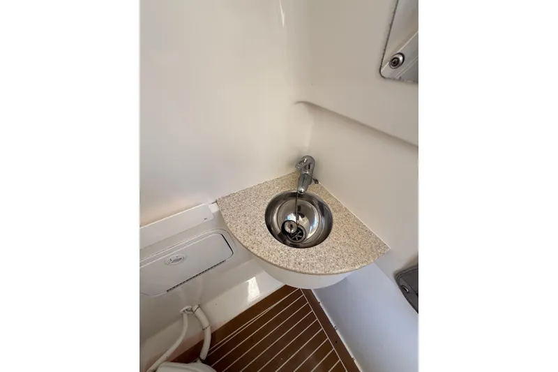 Slide: The Image of Compact sink area on 2015 Regulator 28 Forward Seating boat. - 70