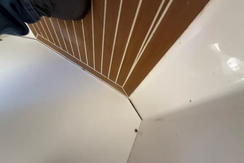 Slide: The Image of 2015 Regulator 28 Forward Seating boat interior with wood and white paneling. - 73