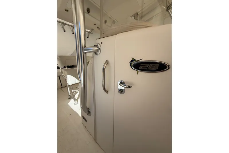 Slide: The Image of 2015 Regulator 28 Forward Seating boat interior with chrome handles and seating. - 76