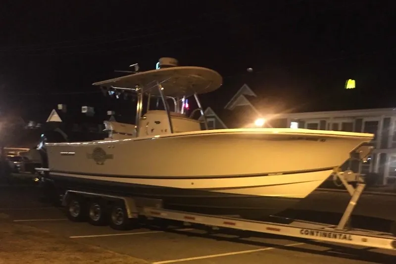 Slide: The Image of 2015 Regulator 28 Forward Seating boat on trailer at night in parking lot. - 8