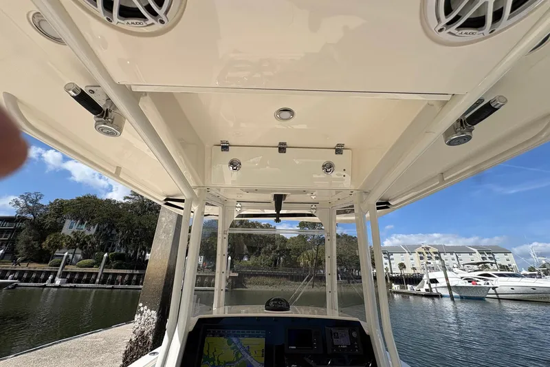 Slide: The Image of 2020 Cobia 240 Center Console boat interior with speakers and navigation system. - 17