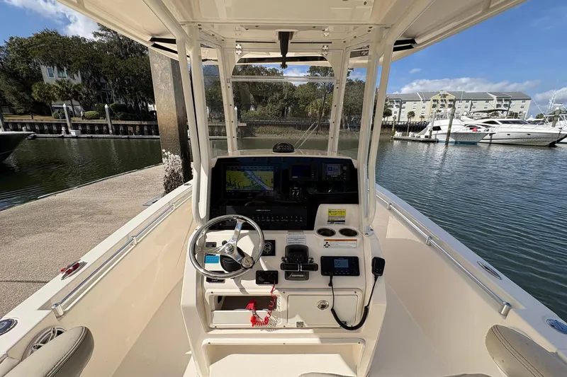 Slide: The Image of 2020 Cobia 240 Center Console boat at marina, featuring modern helm controls. - 18