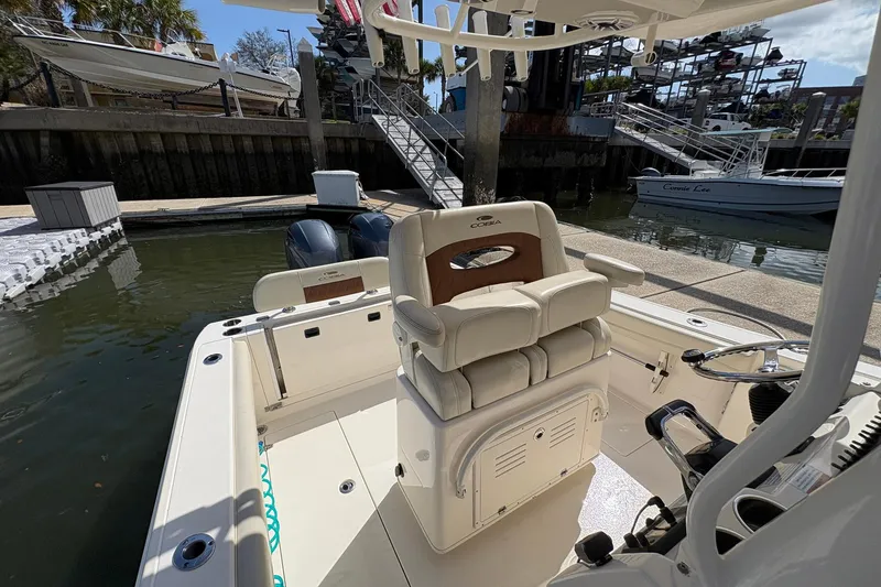 Slide: The Image of 2020 Cobia 240 Center Console boat at dock with dual engines and comfortable seating. - 20