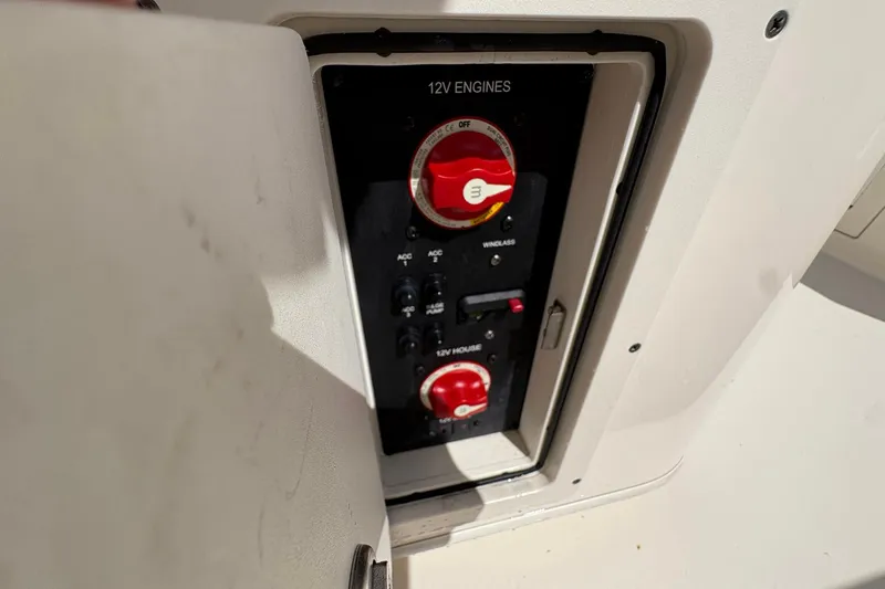 Slide: The Image of 2020 Cobia 240 Center Console boat's 12V engine control panel with switches and dials. - 24