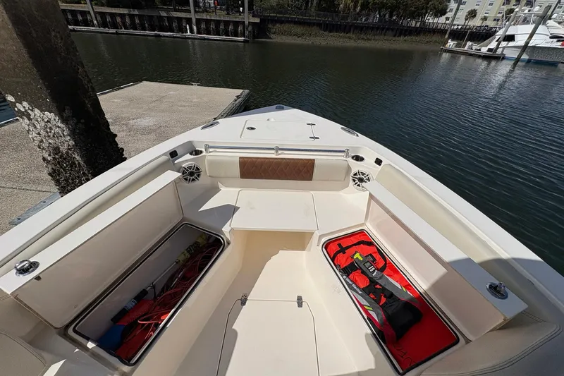 Slide: The Image of 2020 Cobia 240 Center Console boat interior with storage compartments and seating. - 28