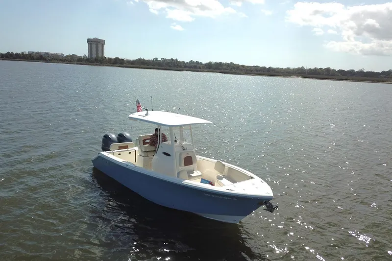 Slide: The Image of 2020 Cobia 240 Center Console boat on calm water under a sunny sky. - 4