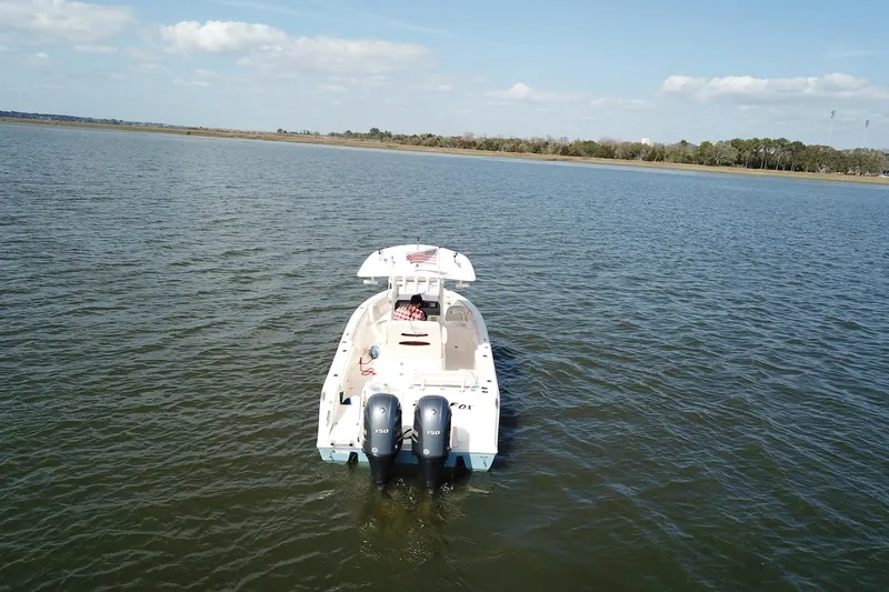 Slide: The Image of 2020 Cobia 240 Center Console boat on calm water under blue sky. - 6