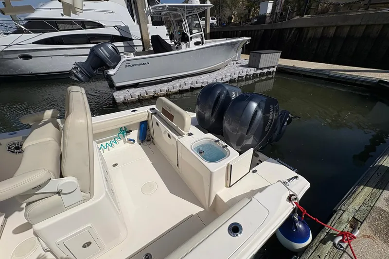 Slide: The Image of 2020 Cobia 240 Center Console boat docked with twin Yamaha engines. - 9