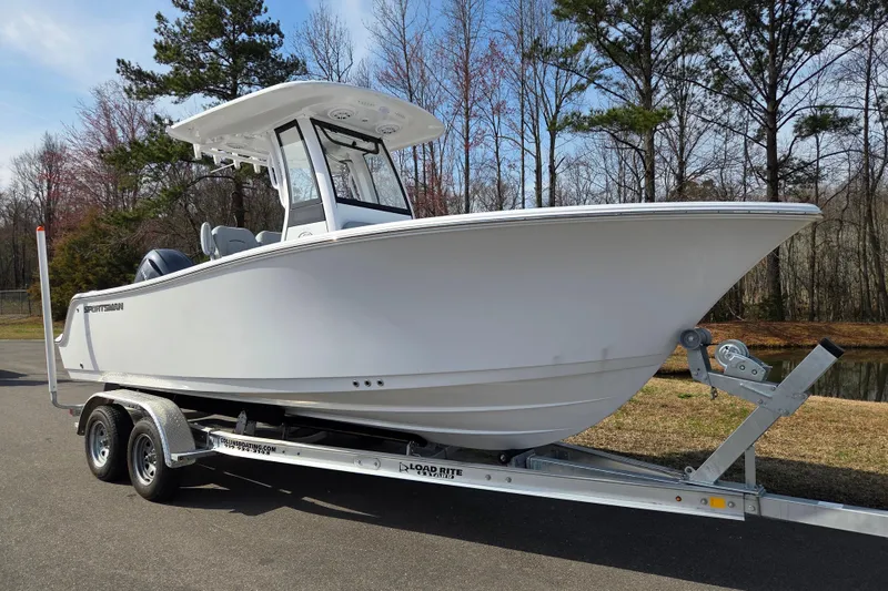 Slide: The Image of 2026 Sportsman Open 212 Center Console boat on trailer, parked outdoors. - 1