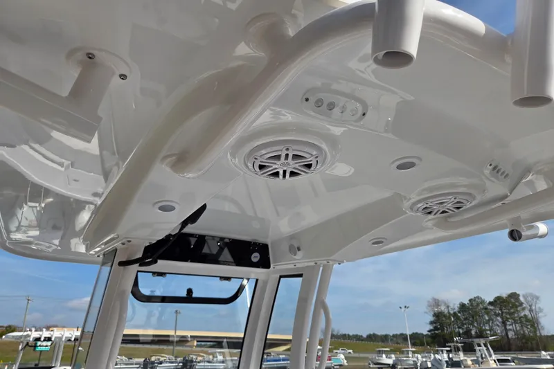 Slide: The Image of 2026 Sportsman Open 212 Center Console boat with speakers and rod holders. - 11