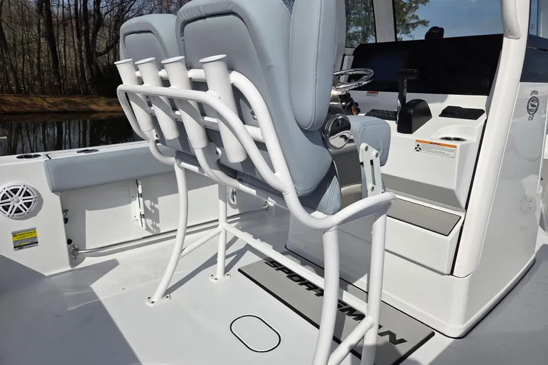 Slide: The Image of 2026 Sportsman Open 212 Center Console boat interior with rod holders and seating. - 16