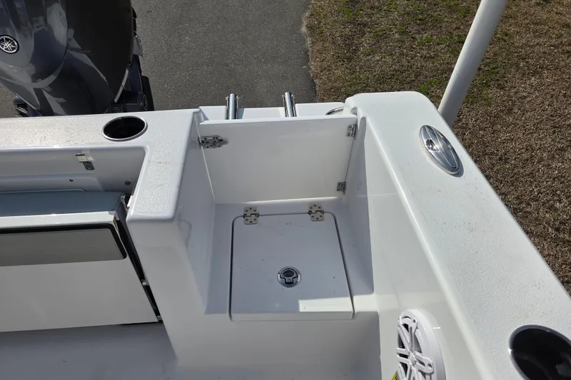 Slide: The Image of 2026 Sportsman Open 212 Center Console boat deck with storage compartment and cup holders. - 19