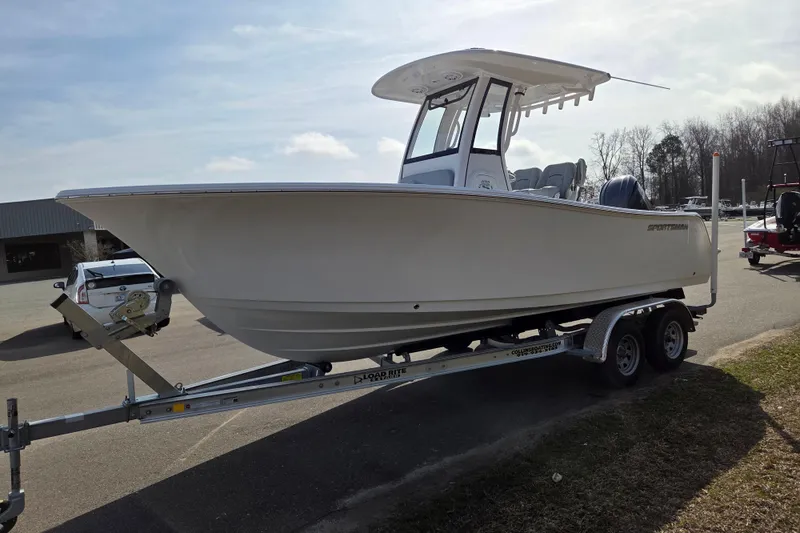 Slide: The Image of 2026 Sportsman Open 212 Center Console boat on trailer, parked outdoors. - 7