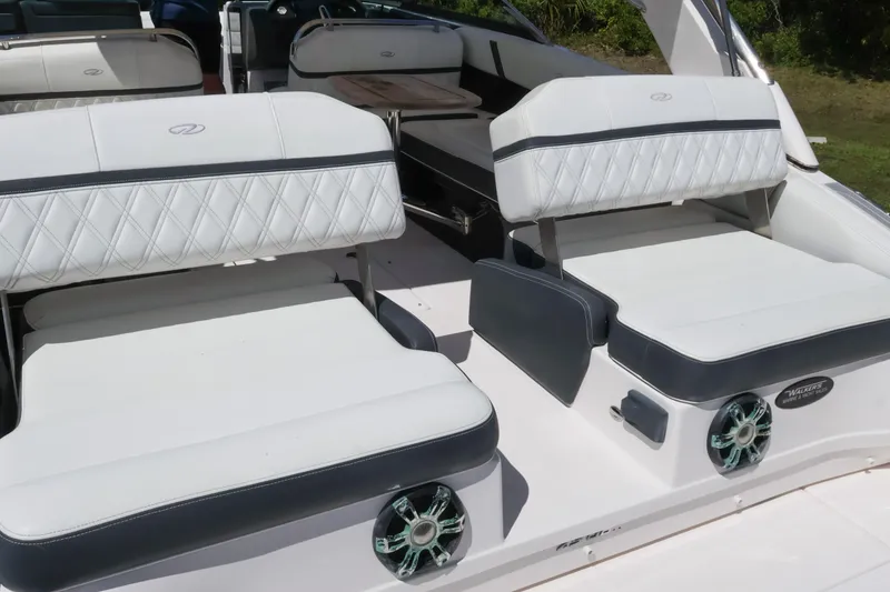 Slide: The Image of 2019 Regal 29 OBX boat interior with white cushioned seating and stylish design. - 15