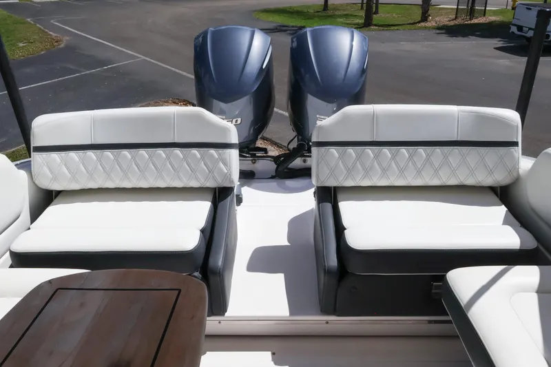 Slide: The Image of 2019 Regal 29 OBX boat with dual outboard engines and luxurious seating. - 17