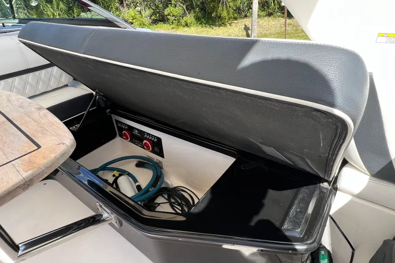 Slide: The Image of Open storage compartment in 2019 Regal 29 OBX boat, showing cables and equipment. - 23