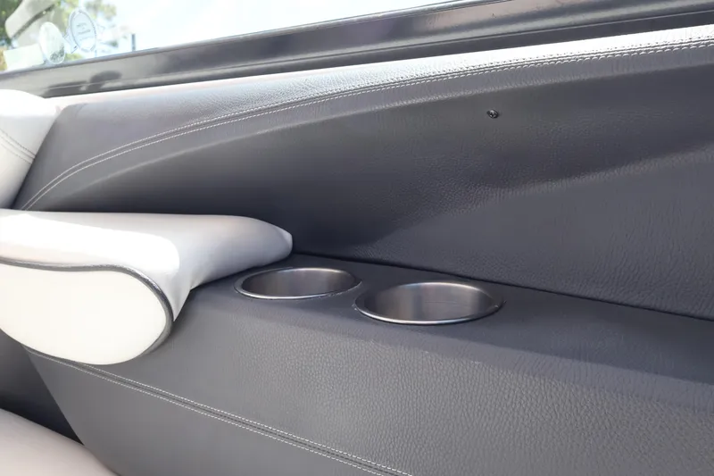 Slide: The Image of 2019 Regal 29 OBX boat interior with cup holders and armrest detail. - 26
