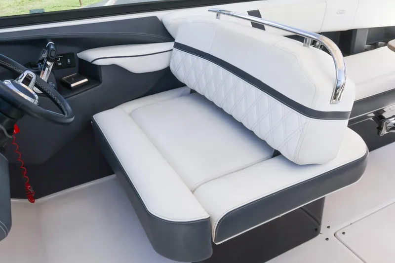 Slide: The Image of 2019 Regal 29 OBX boat interior with white leather seating and steering wheel. - 28