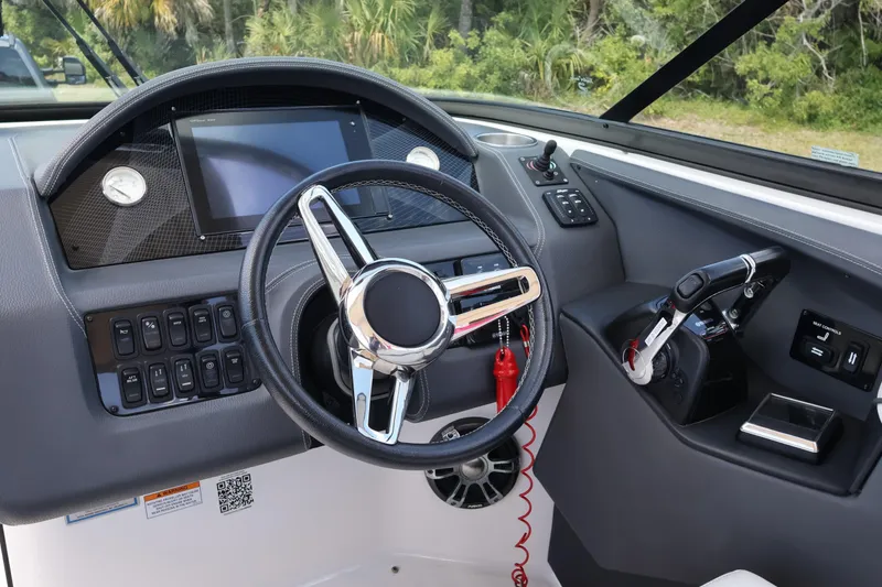 Slide: The Image of 2019 Regal 29 OBX boat dashboard with steering wheel and control panel. - 29