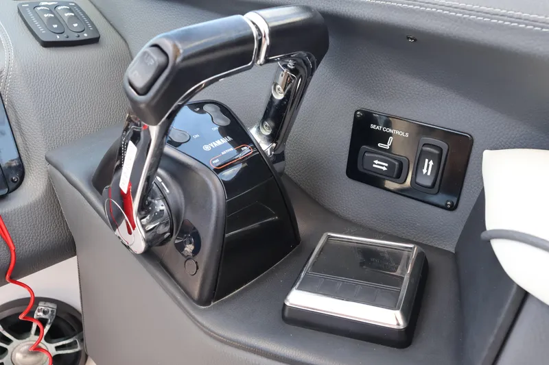 Slide: The Image of Control panel of a 2019 Regal 29 OBX boat with Yamaha throttle and seat controls. - 31