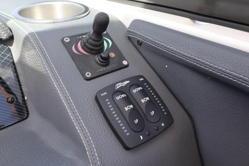 Slide: The Image of Control panel of a 2019 Regal 29 OBX boat with joystick and trim tabs. - 32