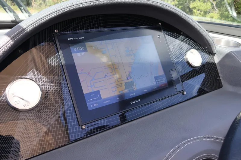 Slide: The Image of Dashboard of a 2019 Regal 29 OBX boat featuring a Garmin GPS display. - 33