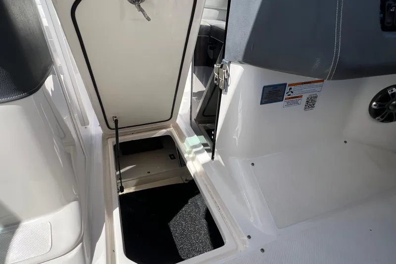 Slide: The Image of 2019 Regal 29 OBX boat interior storage compartment with open hatch. - 35