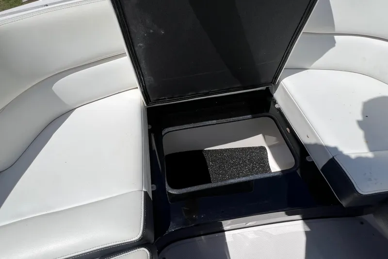 Slide: The Image of Open storage compartment on 2019 Regal 29 OBX boat with white seating. - 40